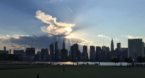 City skyline against cloudy sky