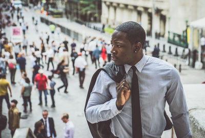 Young man looking at city street