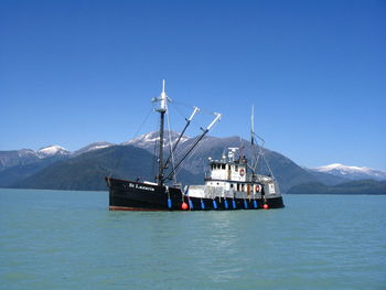 Calm sea with mountain range in background