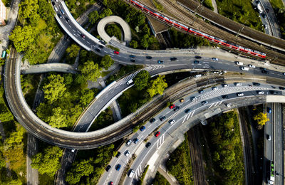 Cars moving on bridge over trees