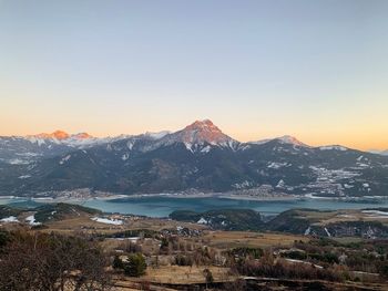 Scenic view of snowcapped mountains against sky during sunset