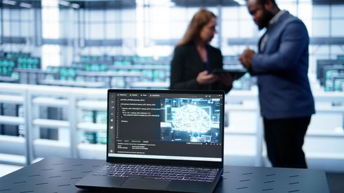 Midsection of man using laptop at office