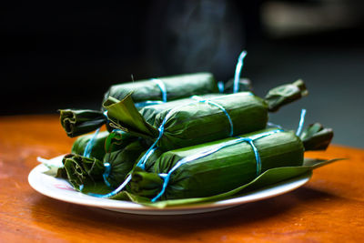 Close-up of green chili peppers in plate on table