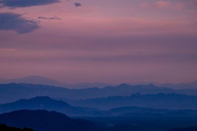 Scenic view of silhouette mountains against sky at sunset