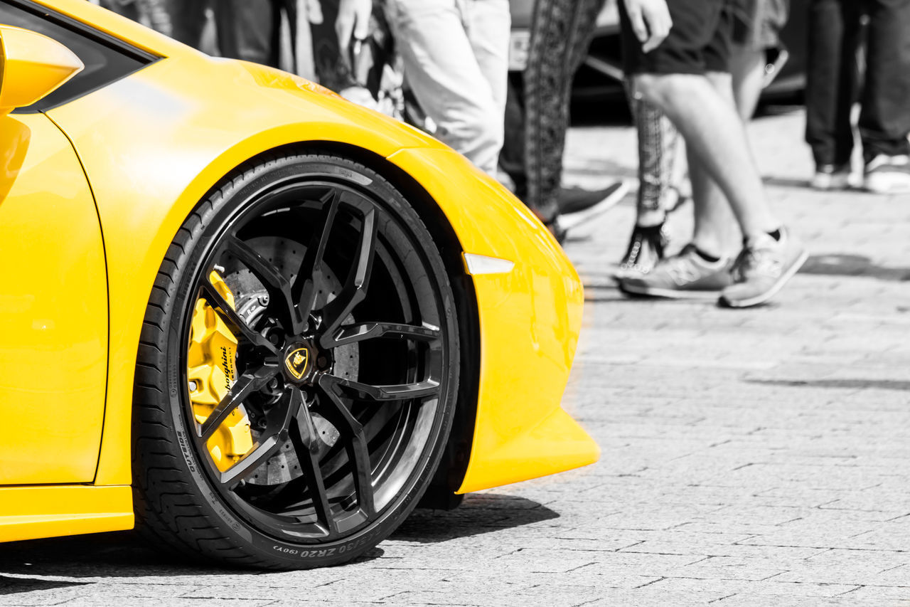 LOW SECTION OF YELLOW MOTORCYCLE ON STREET