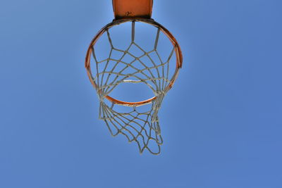 Low angle view of basketball hoop against clear blue sky