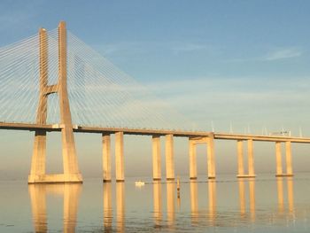 Low angle view of bridge over sea against sky