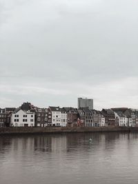 Reflection of the dutch houses on the water in maastricht, the netherlands. 