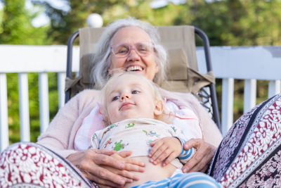 Portrait of smiling family sitting on sofa