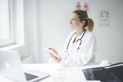 Full length of senior woman using laptop on table