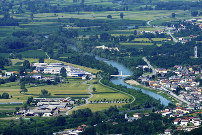 High angle view of trees and buildings on field