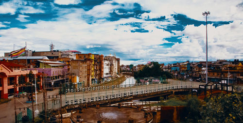 High angle view of bridge over river amidst buildings in city