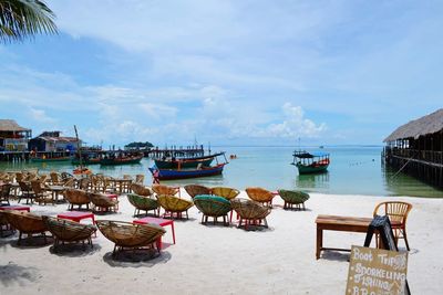 Boats moored on beach against sky