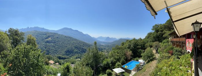 Panoramic shot of trees and houses against sky