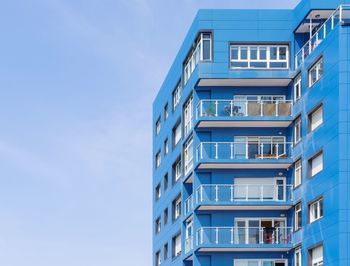 Low angle view of blue building against clear sky