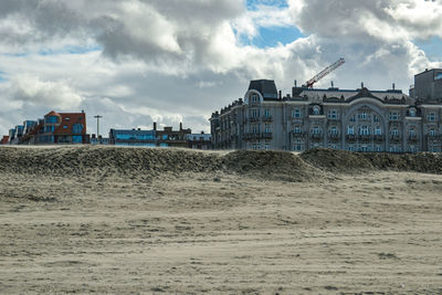 Buildings on beach against sky in city