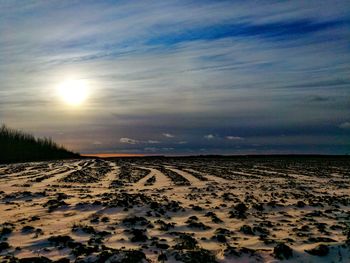 Scenic view of land against sky during sunset