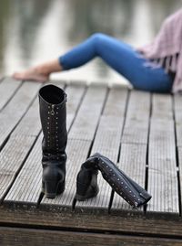 Low section of woman relaxing on pier