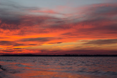 Scenic view of sea against romantic sky at sunset