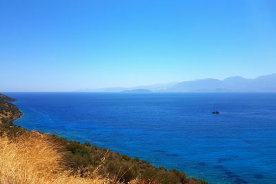 Scenic view of sea against clear blue sky