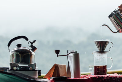 Close-up of drink on table against sky