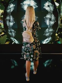 Rear view of woman standing in store