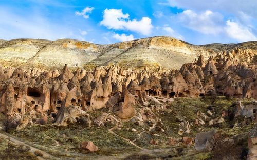 View of rock formations against cloudy sky