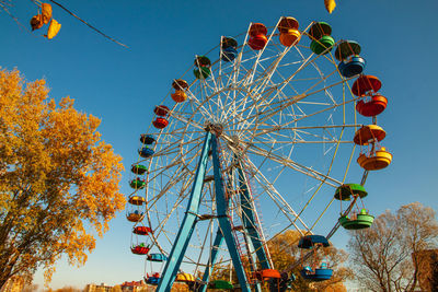 Ferris wheel with colorful booths in an amusement park