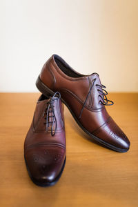 Close-up of shoes on wooden floor