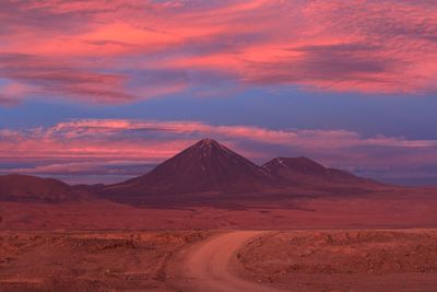 Scenic view of desert against sky during sunset