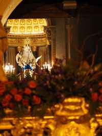 Illuminated statue against building at night