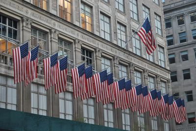 Low angle view of flags against building