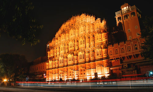 Low angle view of illuminated buildings against sky at night