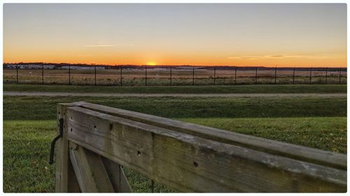 Scenic view of field against sky during sunset