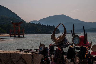 View of boats in river against mountains
