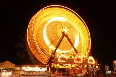 Low angle view of illuminated ferris wheel