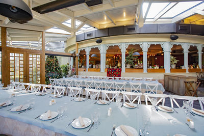 Empty chairs and tables in restaurant