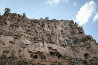 Low angle view of rock formation against sky