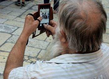 High angle view of man using mobile phone