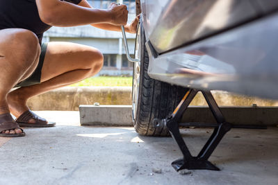 Low section of man skateboarding on car