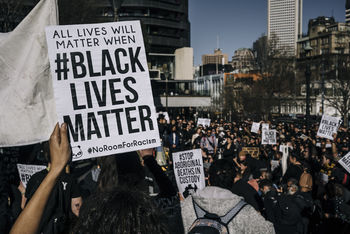 Close-up of protestor holding text on papers