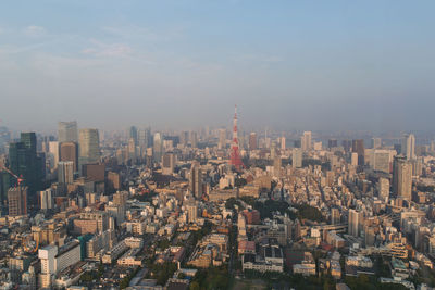 Cityscape against sky. view over tokyo tower from mori tower, roppongi hills, tokyo, japan