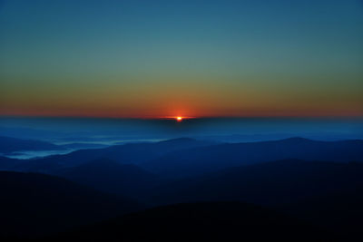 Scenic view of silhouette mountains against sky during sunset