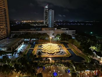 High angle view of city lit up at night