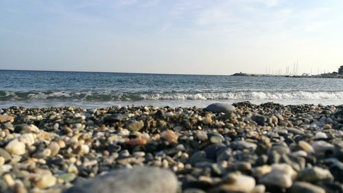 Rocks on beach against sky