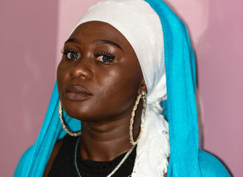 African woman with white and blue headdress symbolizing mother teresa