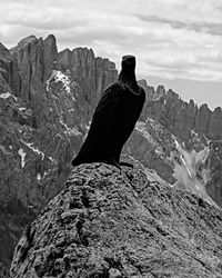 Rock formation on mountain against cloudy sky