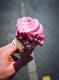 Close-up of hand holding ice cream cone