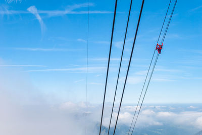 Low angle view of cables against blue sky