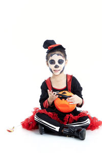 View of girl wearing mask against white background